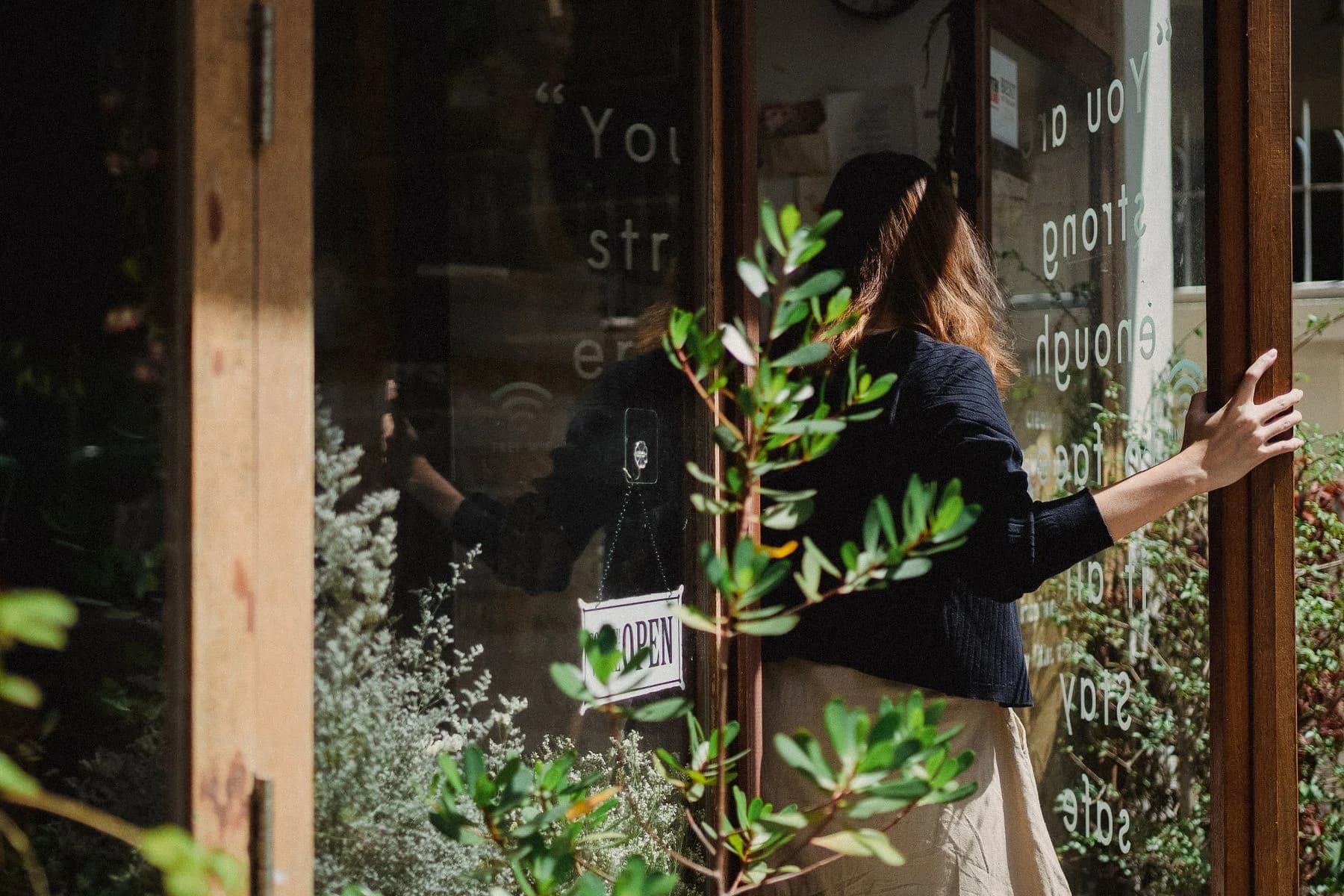 A florist at the door of her neighbourhood flower shop