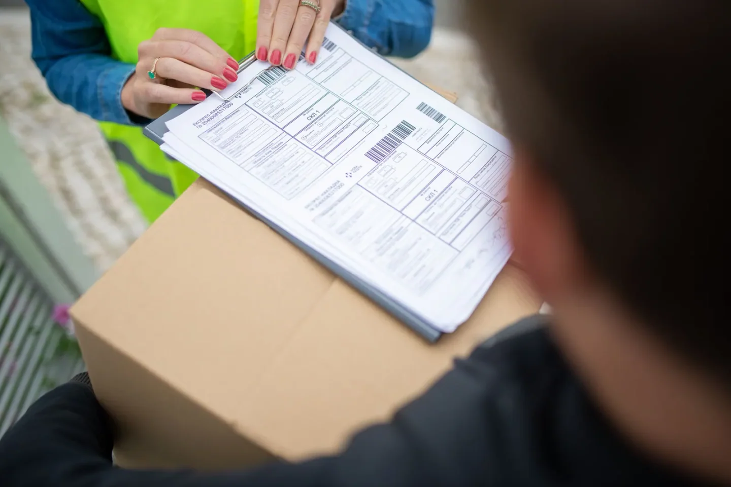 Courier verifying barcode manifest during merchant collection